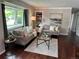 Inviting living room featuring a large window, hardwood floors, and neutral decor at 8610 Jolene Dr, Denver, CO 80229