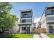 Modern three-story home with a balcony, landscaped front yard, and contemporary design at 1713 Grove St, Denver, CO 80204