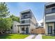 Modern three-story home with a balcony, landscaped front yard, and contemporary design at 1713 Grove St, Denver, CO 80204
