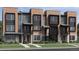 Modern townhome with a well-maintained lawn and a stylish combination of neutral and black exterior accents at 825 Josephine Way, Superior, CO 80027