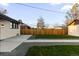 A backyard featuring a concrete patio, green grass, and gravel at 3250 N Clayton St, Denver, CO 80205