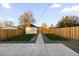 A backyard featuring a concrete patio, green grass, and gravel at 3250 N Clayton St, Denver, CO 80205