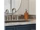 Modern bathroom with stylish faucet, wood accent, and sleek countertop for a clean and sophisticated design at 3250 N Clayton St, Denver, CO 80205