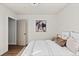 A bedroom with light-colored walls and light-colored bedding and a stylish abstract painting for a serene retreat at 3250 N Clayton St, Denver, CO 80205