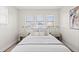 Bright bedroom features three windows, bedside tables, and modern decor for a cozy and inviting atmosphere at 3250 N Clayton St, Denver, CO 80205