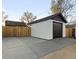 Detached garage in backyard with brown door at 3250 N Clayton St, Denver, CO 80205
