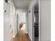 Hallway with archway leading to rooms and a modern bathroom with a dark vanity and unique tile floor at 3250 N Clayton St, Denver, CO 80205