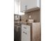 Close-up of a kitchen counter with light marbled stone countertops and white shaker cabinets at 3250 N Clayton St, Denver, CO 80205