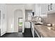 Modern kitchen with black and white design, stainless steel appliances, and contrasting black floors at 3250 N Clayton St, Denver, CO 80205