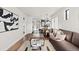 Open-concept living room, kitchen, and dining area featuring hardwood floors and abundant natural light at 3250 N Clayton St, Denver, CO 80205