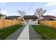 A backyard featuring a concrete patio, green grass, and gravel at 3250 N Clayton St, Denver, CO 80205