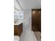 Stylish bathroom with wood vanity, stone-tiled shower, and modern finishes for a spa-like experience at 6641 Ash St, Commerce City, CO 80022