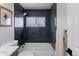 Sleek bathroom features modern tiles, a bathtub-shower combination, and stylish fixtures at 6641 Ash St, Commerce City, CO 80022
