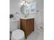 Well-lit bathroom featuring modern fixtures, a wooden vanity, and a sleek, updated design at 6641 Ash St, Commerce City, CO 80022