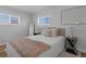 Cozy bedroom boasts natural light, neutral colors, and ample space, creating a tranquil retreat at 6641 Ash St, Commerce City, CO 80022