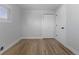 Spacious bedroom with hardwood floors, a large window, and a closet for plenty of storage space at 6641 Ash St, Commerce City, CO 80022