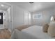 Neutral bedroom with closet, large window for natural light, and door to ensuite bathroom at 6641 Ash St, Commerce City, CO 80022