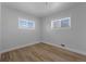 Bright bedroom has hardwood floors and two windows letting in ample natural light at 6641 Ash St, Commerce City, CO 80022