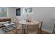 Dining area adjacent to the living room, showcasing natural light and hardwood flooring at 6641 Ash St, Commerce City, CO 80022