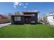 Charming home featuring a well-manicured lawn and modern, dark-colored exterior at 6641 Ash St, Commerce City, CO 80022
