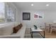Bright living room with hardwood floors, neutral sofa, and modern decor at 6641 Ash St, Commerce City, CO 80022