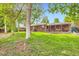 View of the backyard featuring a brick house and covered patio perfect for outdoor enjoyment at 13558 E Center Ave, Aurora, CO 80012