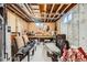Unfinished basement with exposed beams, concrete walls, and a pegboard workbench; ready for customization at 13558 E Center Ave, Aurora, CO 80012