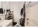 Clean bathroom with a shower-tub combination, modern vanity, and decorative storage shelves at 13558 E Center Ave, Aurora, CO 80012