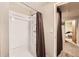 Full bathroom features a shower stall with a dark brown shower curtain; neutral walls and trim at 13558 E Center Ave, Aurora, CO 80012