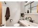 Bathroom showcasing a sink, toilet, and shower area, enhanced by a large decorative mirror at 13558 E Center Ave, Aurora, CO 80012