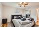 Spacious bedroom with a mirrored closet door, ceiling fan, and a cozy bed with gray bedding at 13558 E Center Ave, Aurora, CO 80012