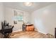 Bright bedroom with hardwood floors, a work desk, and a comfortable orange beanbag chair at 13558 E Center Ave, Aurora, CO 80012