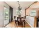 Cozy dining room featuring hardwood floors and a decorative light fixture above the wooden table at 13558 E Center Ave, Aurora, CO 80012