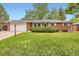 Charming single-story brick home with a well-manicured lawn and attached garage at 13558 E Center Ave, Aurora, CO 80012