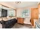 Kitchen with granite countertops, black cabinets, and view into dining area at 13558 E Center Ave, Aurora, CO 80012