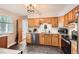 Well-lit kitchen with granite countertops, stainless steel appliances, and wooden cabinets at 13558 E Center Ave, Aurora, CO 80012