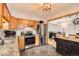 Open kitchen with granite counters, stainless appliances, and view to living area at 13558 E Center Ave, Aurora, CO 80012