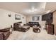 Cozy living room features comfortable couches, an entertainment center, and neutral color decor at 13558 E Center Ave, Aurora, CO 80012