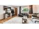 Inviting living room featuring hardwood floors, a comfy couch, and a large window at 13558 E Center Ave, Aurora, CO 80012