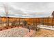 Charming backyard with raised garden beds, stone pathways, and a privacy fence perfect for outdoor enjoyment at 15920 Hayloft Ln, Parker, CO 80134
