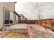 Inviting backyard with a concrete patio, stone landscaping, and a privacy fence offers a relaxing outdoor space at 15920 Hayloft Ln, Parker, CO 80134