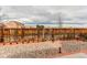 Beautifully landscaped backyard with stone accents, a privacy fence, and garden details creates a serene setting at 15920 Hayloft Ln, Parker, CO 80134