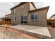 Back of the home featuring a concrete patio and low-maintenance yard at 15920 Hayloft Ln, Parker, CO 80134
