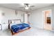 Spacious bedroom with neutral carpet, ceiling fan, and ensuite bathroom access at 15920 Hayloft Ln, Parker, CO 80134