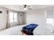 Bright bedroom with a ceiling fan, large windows and plush carpet at 15920 Hayloft Ln, Parker, CO 80134