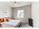 Cozy bedroom with neutral tones, carpet flooring, ceiling fan, and a bright window at 15920 Hayloft Ln, Parker, CO 80134