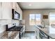Modern kitchen featuring granite countertops, stainless steel appliances, and white cabinets at 15920 Hayloft Ln, Parker, CO 80134