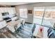 Open kitchen with a kitchen island, stainless steel appliances, hardwood floors, and sliding doors to backyard at 15920 Hayloft Ln, Parker, CO 80134