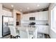 Bright kitchen featuring stainless steel appliances, granite countertops, and a kitchen island with bar seating at 15920 Hayloft Ln, Parker, CO 80134