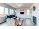 Cozy living room with a blue sofa, patterned chair, fireplace, and a flat screen tv at 15920 Hayloft Ln, Parker, CO 80134